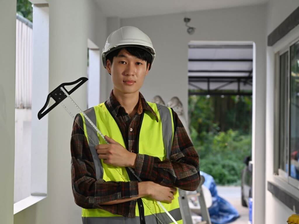 a male architect posing with measuring tool