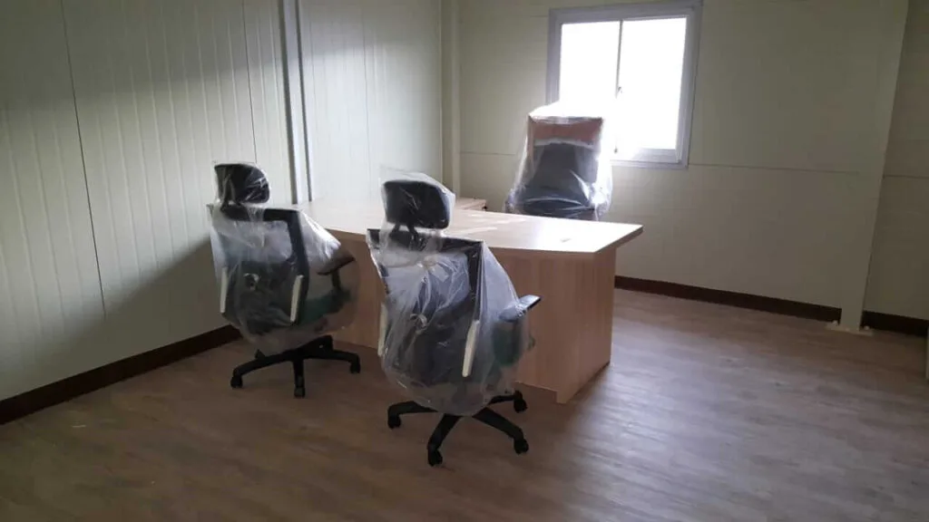 new and sealed chairs and table in an office room